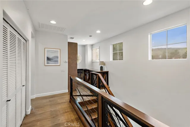 a view of an entryway with wooden floor