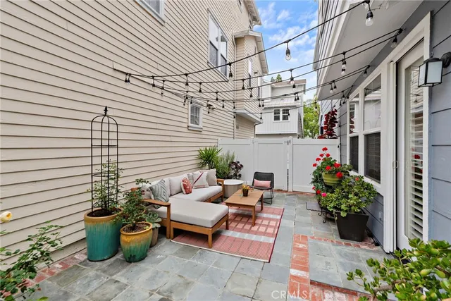 a view of a patio with chair and potted plants