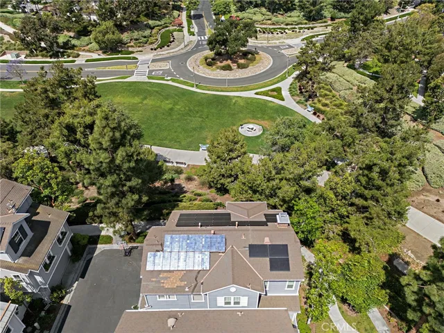 a view of a swimming pool with a patio and garden