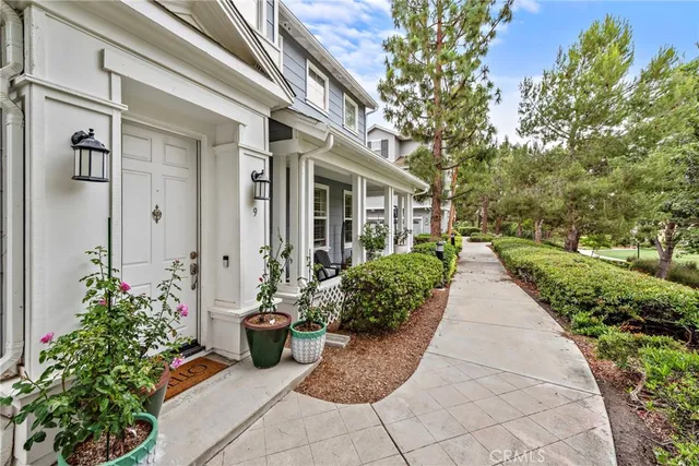 a view of a pathway with flower pots
