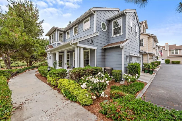 a front view of a house with a garden