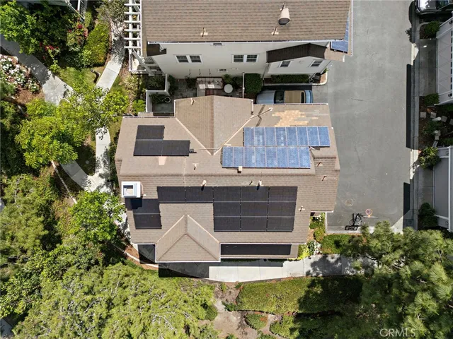 an aerial view of a house with yard and parking