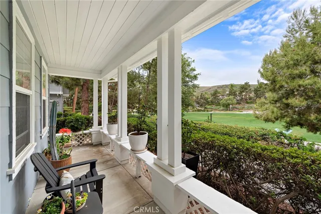 a view of a porch with furniture and garden
