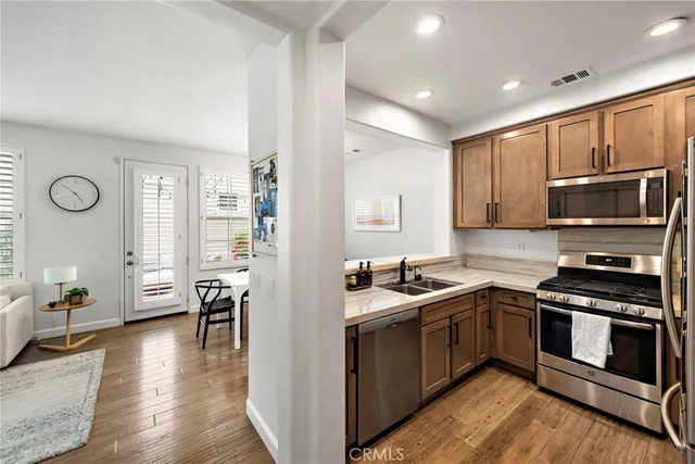 a kitchen with a sink stove top oven and microwave