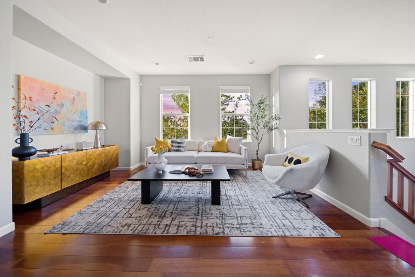 a living room with furniture window and wooden floor