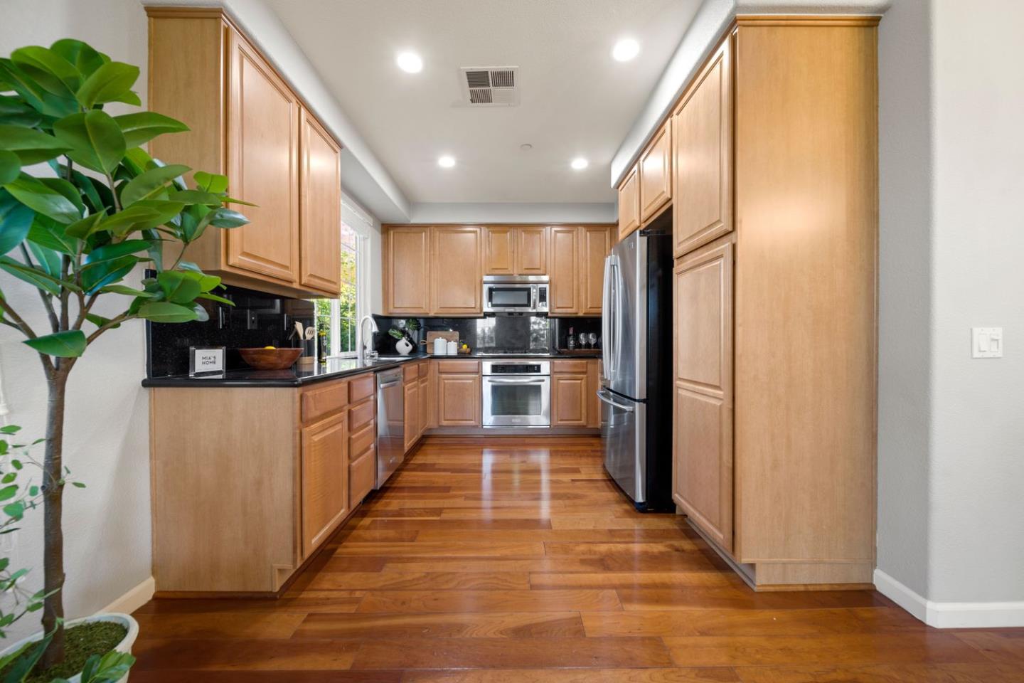 600 Mente Linda Loop Milpitas, CA 95035 - Photo 11 of 29 a kitchen with stainless steel appliances a refrigerator and a stove top oven
