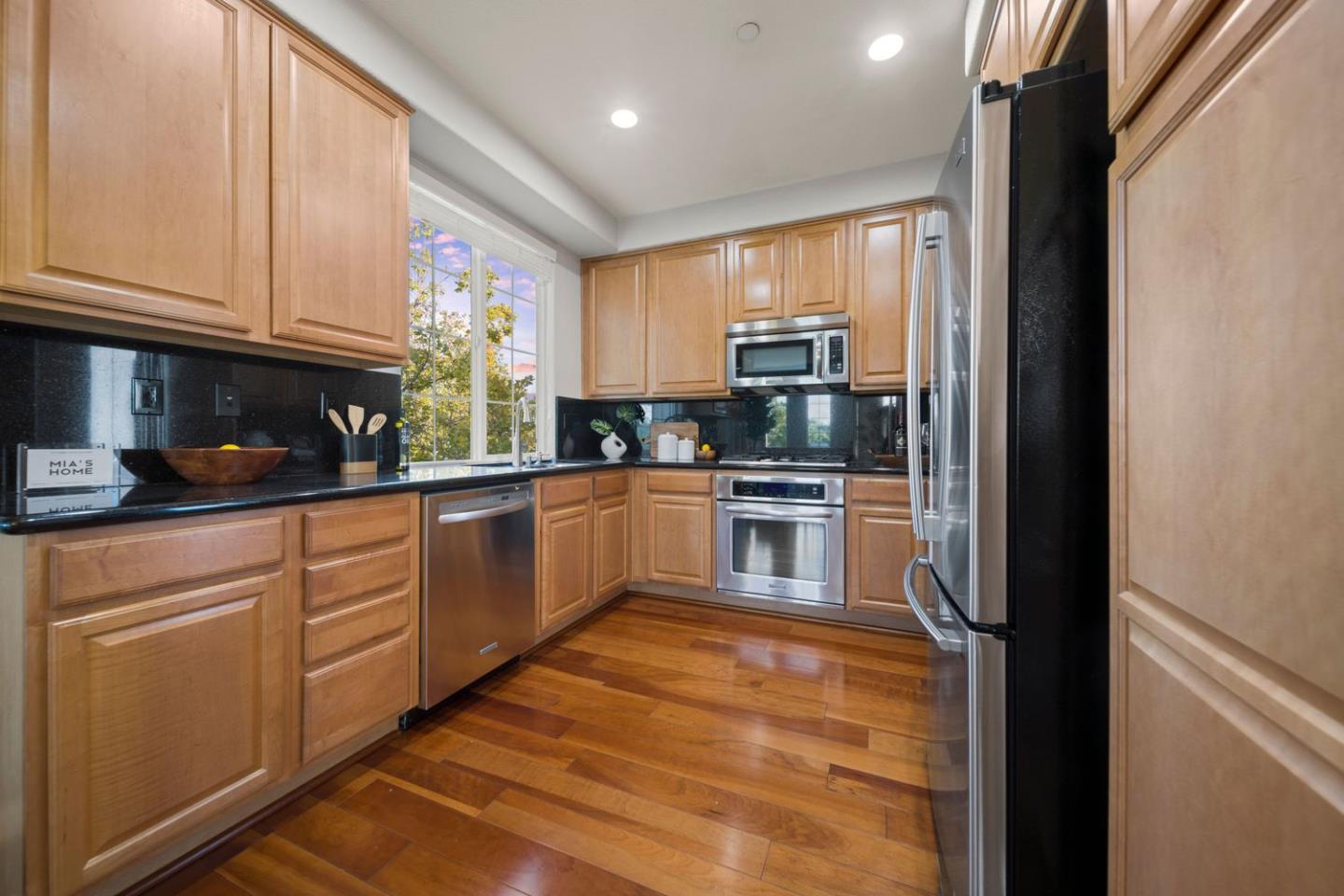 600 Mente Linda Loop Milpitas, CA 95035 - Photo 12 of 29 a kitchen with stainless steel appliances granite countertop a refrigerator sink and cabinets