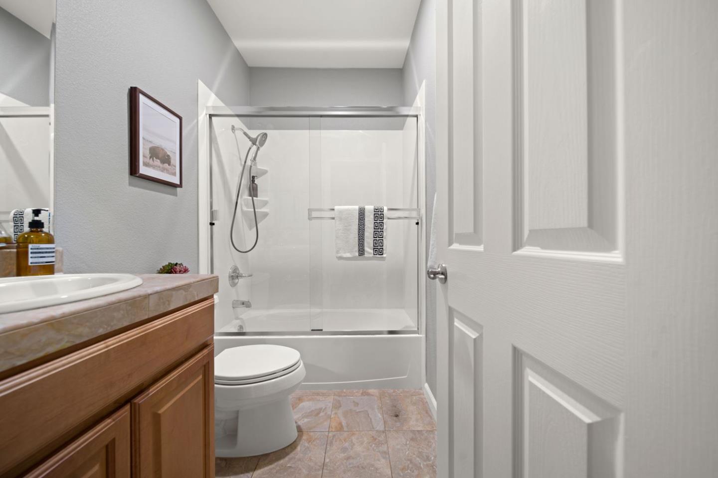 600 Mente Linda Loop Milpitas, CA 95035 - Photo 20 of 29 a bathroom with a granite countertop bathtub shower sink mirror and toilet