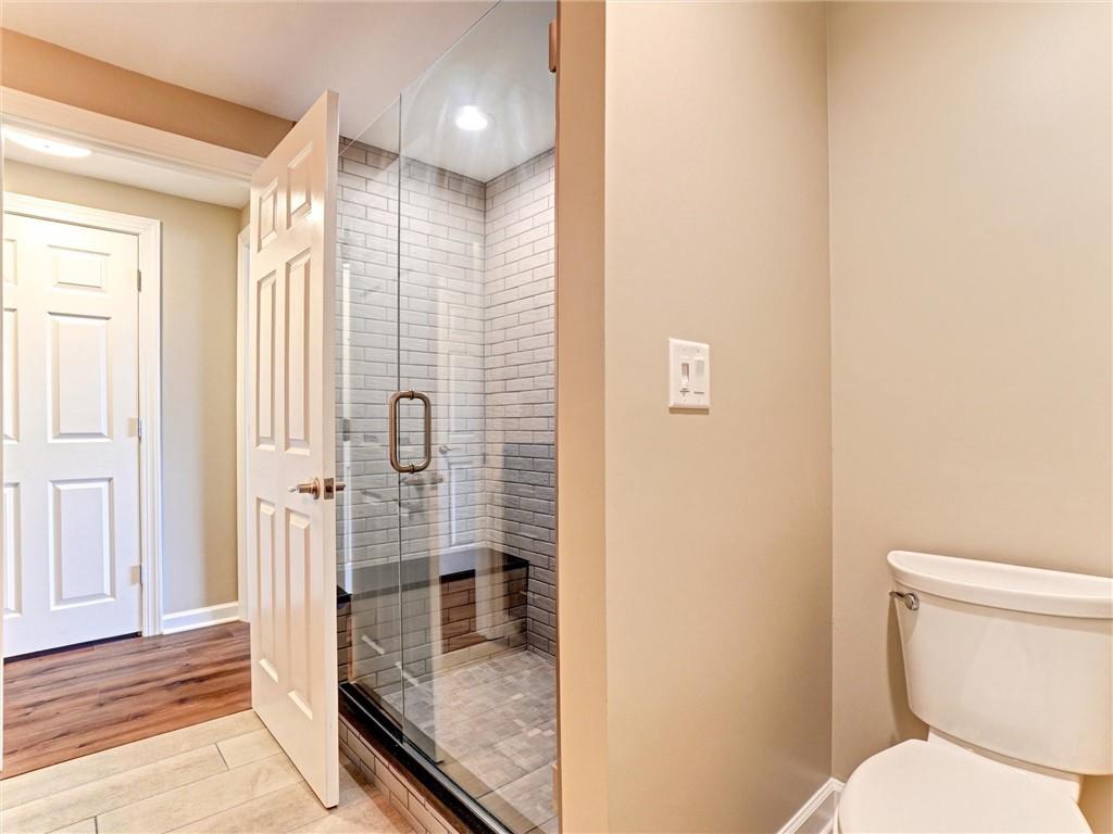 3435 Kingsboro Road Northeast, Unit 1601 Atlanta, GA 30326 - Photo 28 of 54 a bathroom with a shower and toilet