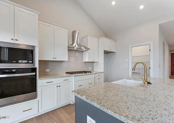 a kitchen with granite countertop a stove and a sink