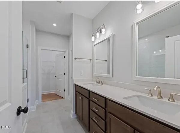 a bathroom with a granite countertop sink a toilet and shower