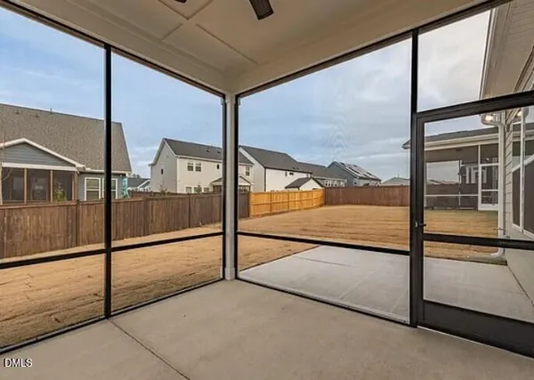 a view of an empty room with wooden floor fire place