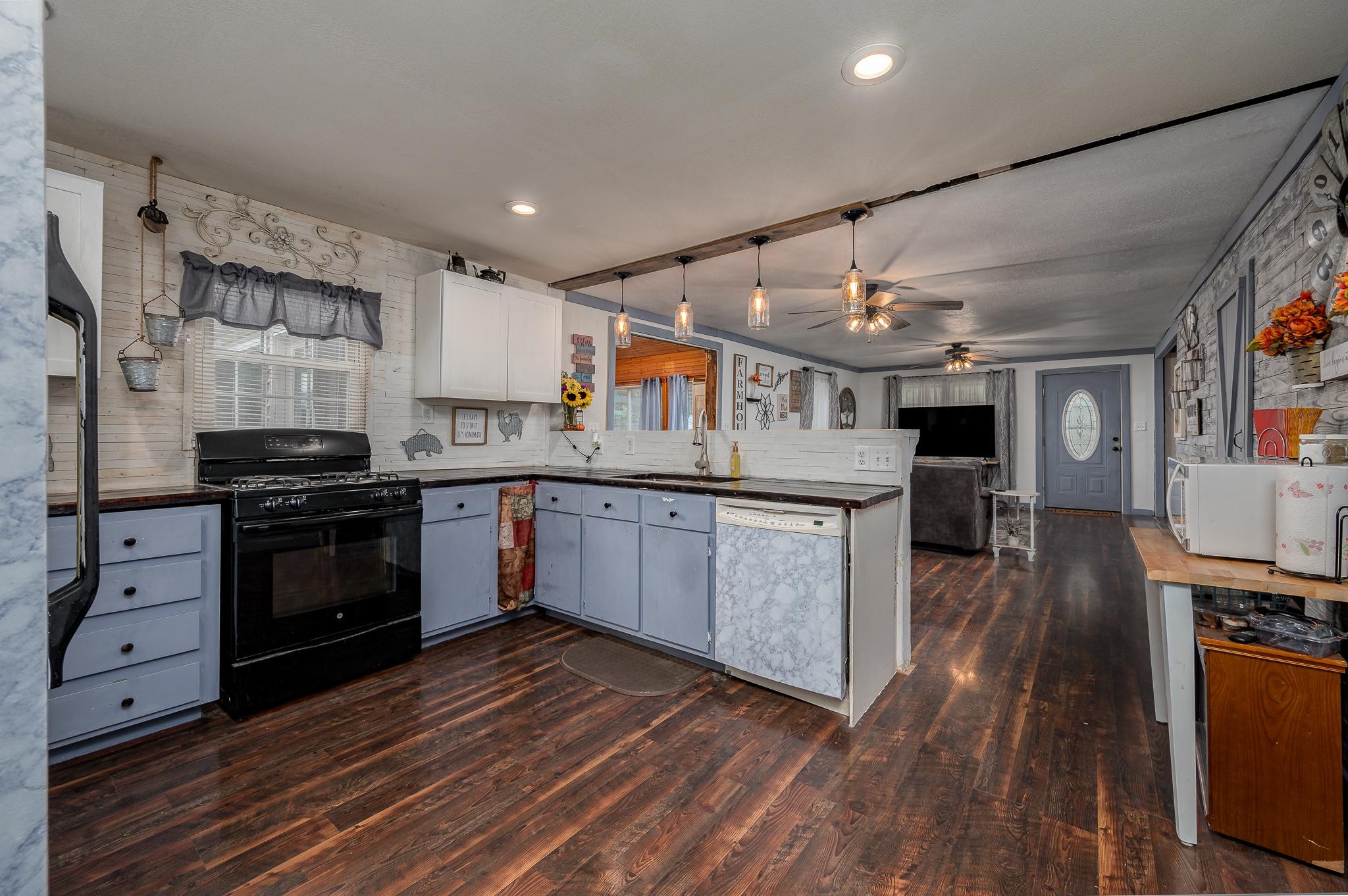 1430 Duncan Road Manchester, TN 37355 - Photo 8 of 31 a kitchen with stainless steel appliances granite countertop a stove and cabinets