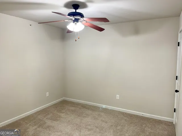 an empty room with a fan