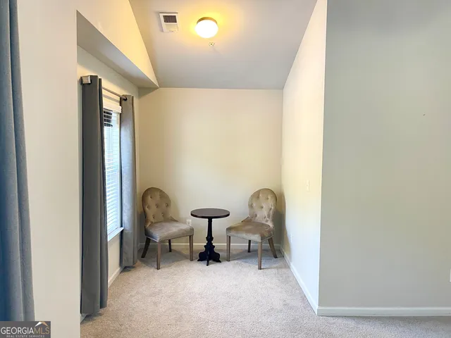 a living room with furniture and a chair