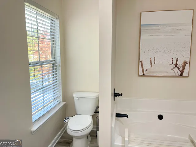 a white toilet sitting next to a bathroom sink