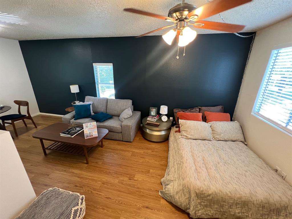 4209 Avenue B, Unit 203 Austin, TX 78751 - Photo 3 of 6 a living room with furniture and a chandelier