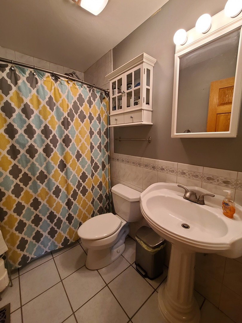419 Foster Road Wauconda, IL 60084 - Photo 24 of 32 a bathroom with a sink toilet and a mirror
