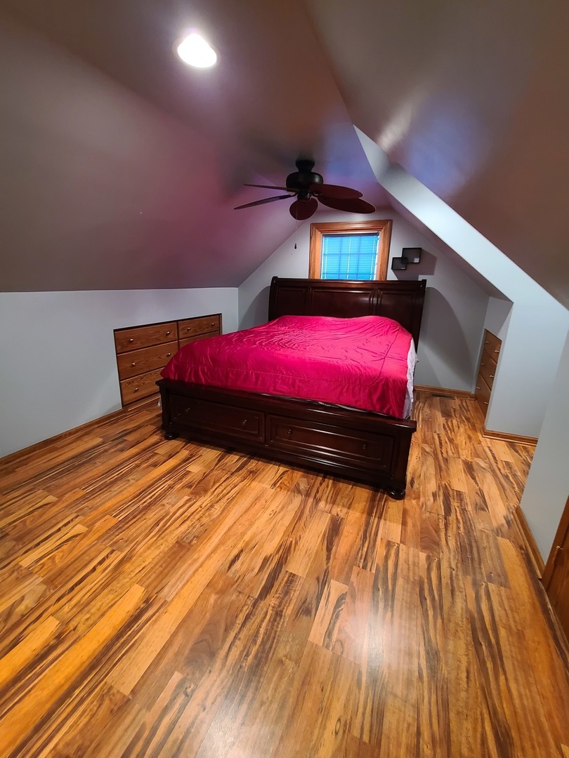 419 Foster Road Wauconda, IL 60084 - Photo 5 of 32 a bedroom with a bed and wooden floor
