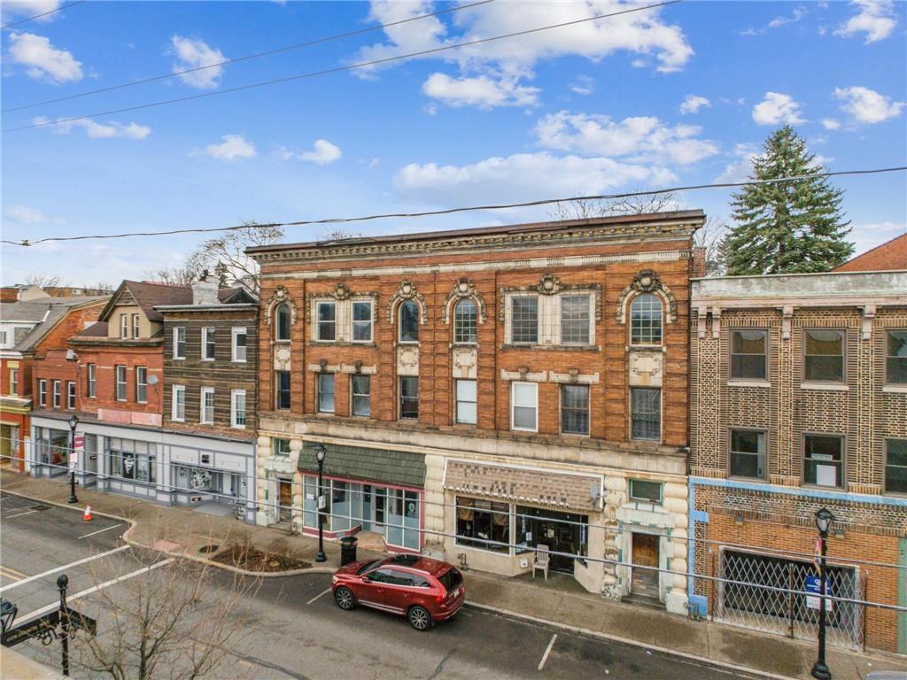 215-217 Brownsville Road Pittsburgh, PA 15210 - Photo 2 of 9 a city street lined with buildings and a yard