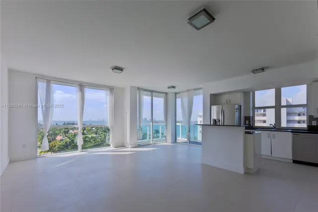 a view of kitchen with stainless steel appliances refrigerator oven and cabinets
