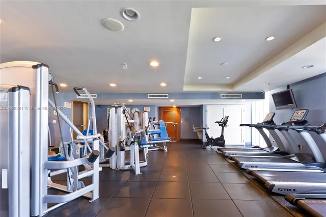 a bathroom with a shower and a glass door