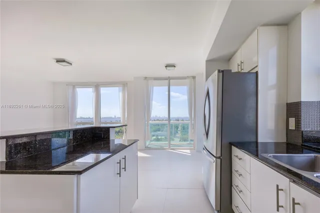 a kitchen with stainless steel appliances and white cabinets