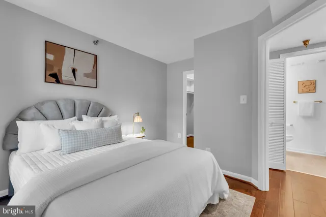 a bedroom with a bed and wooden floor