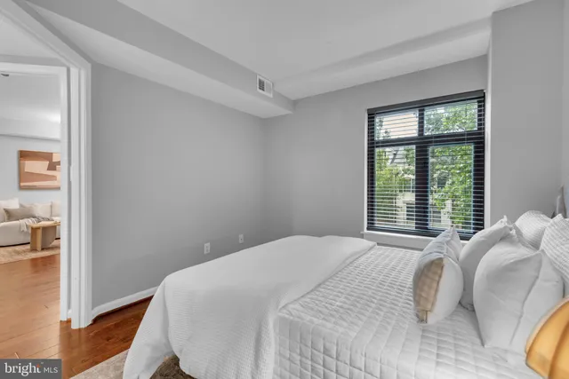 a bedroom with a bed and a window