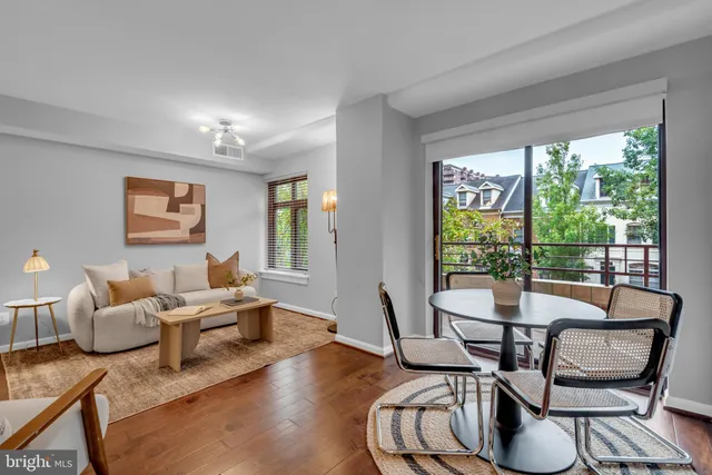 a living room with furniture and a floor to ceiling window