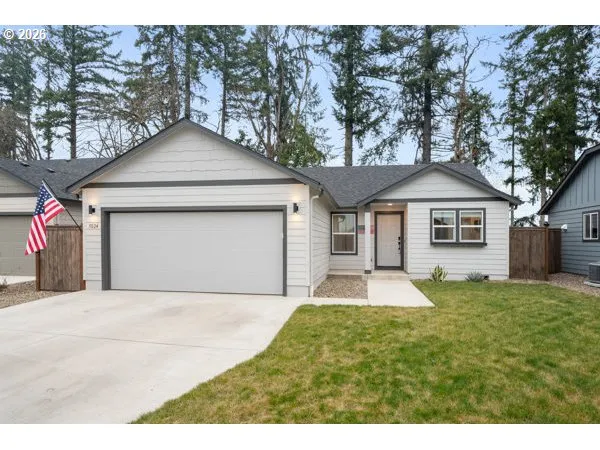 a front view of a house with yard and garage