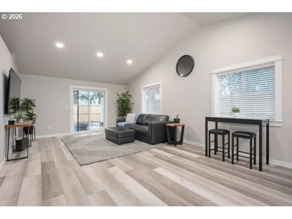 a living room with furniture a window and a potted plant