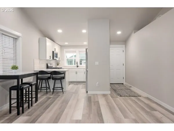 a open kitchen with stainless steel appliances refrigerator dining table and chairs