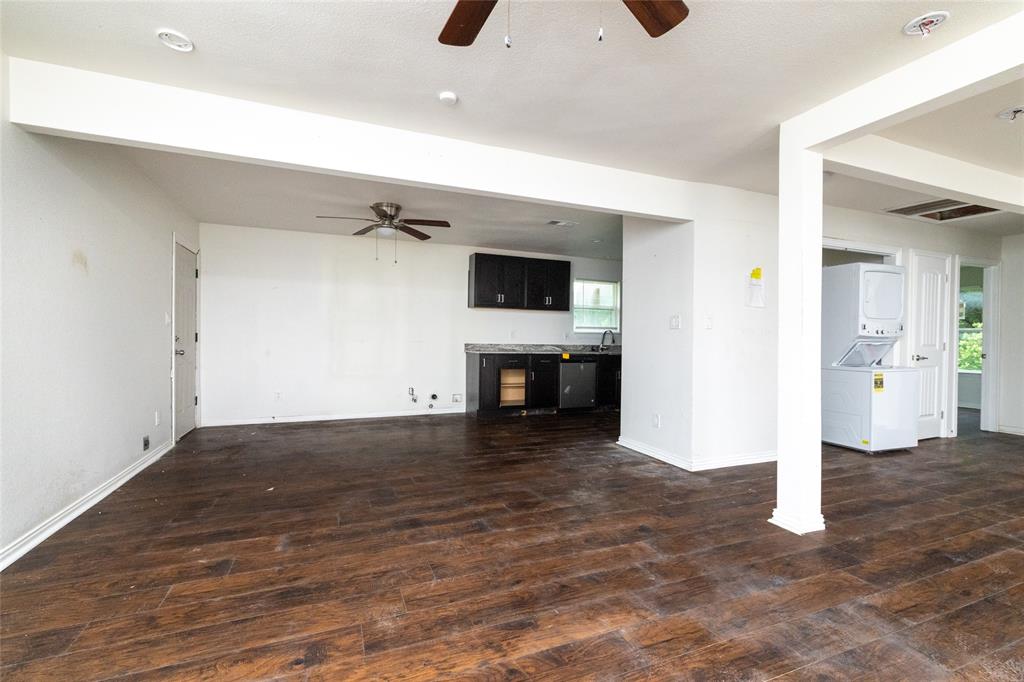 805 East Belt Line Road DeSoto, TX 75115 - Photo 5 of 15 wooden floor in an empty room with a fireplace and a window