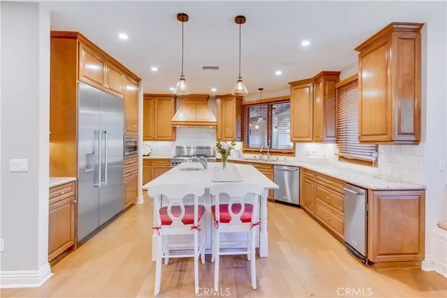 a kitchen with stainless steel appliances a sink stove and refrigerator