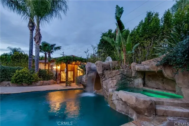 a living room with a couch and a chandelier