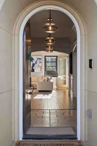 a living room with furniture and a chandelier
