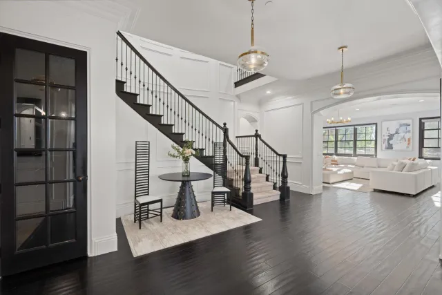 a view of entryway and hall with wooden floor
