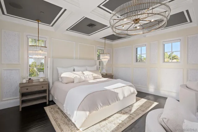 a bedroom with a bed and a chandelier