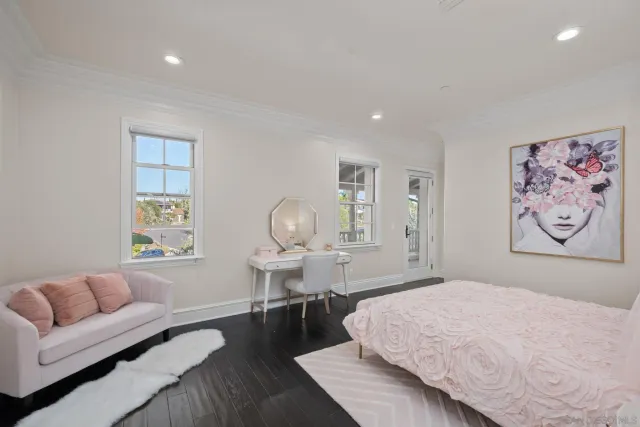 a spacious bedroom with a bed a couch and a window