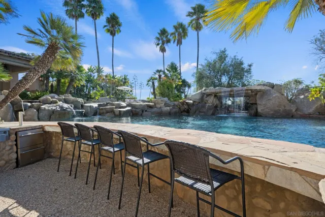 a view of backyard with outdoor seating and plants