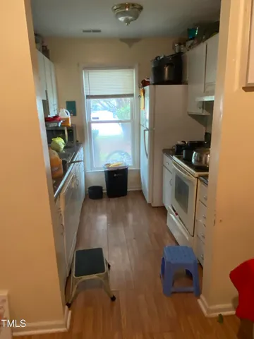 a kitchen with stainless steel appliances a refrigerator and a stove