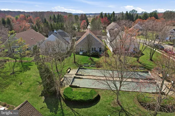 a view of a house with backyard and a tree