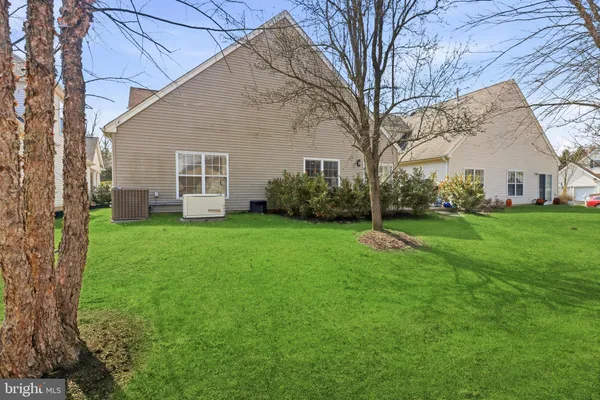 a living room with furniture a rug and a wooden floor