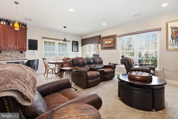 a view of a dining room with furniture and a chandelier