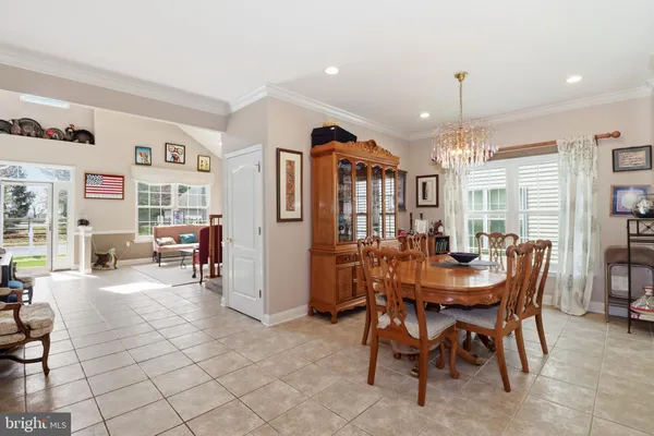 a bedroom with a bed a couch and a flat screen tv