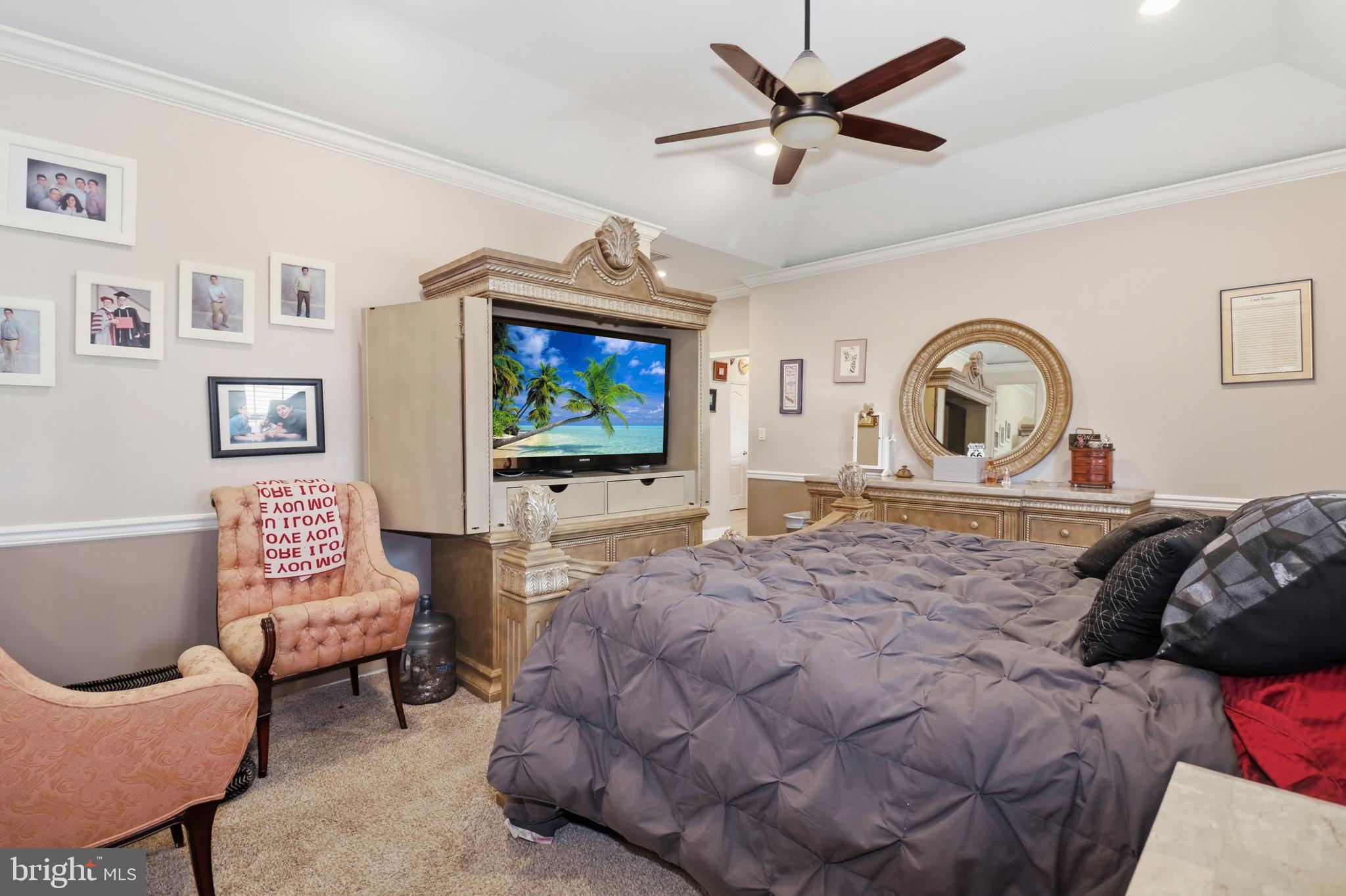 12 Cardinal Flower Lane Princeton Junction, NJ 08550 - Photo 27 of 62 a bedroom with a bed a couch and a flat screen tv