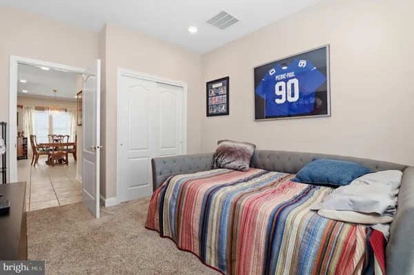 a bed room with a bed and a chair