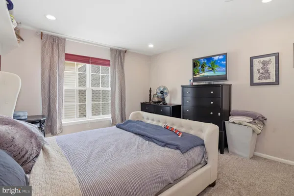 a view of a patio with couches table and chairs and potted plants