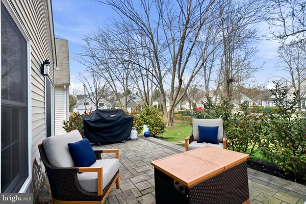 a living room with furniture and a book shelf